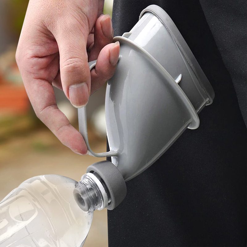 Hand holding the urinal funnel attached to a plastic bottle