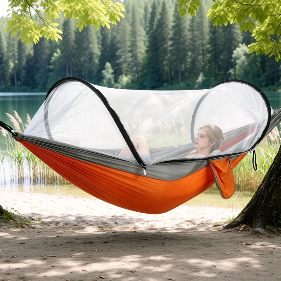 Bug-net hammock strung between trees on a hike