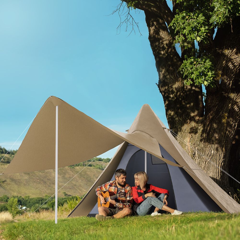 Couple relaxing in a teepee tent at camp